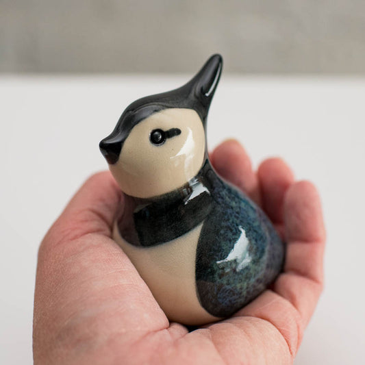 Small ceramic Lapwing sculpture in a hand