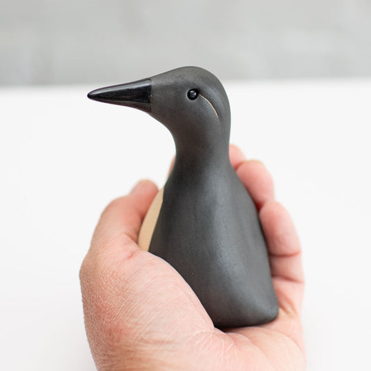 Small Guillemot sculpture in a hand