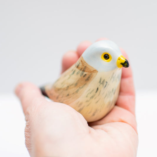 Small Ceramic Kestrel Sculpture held in a person's palm