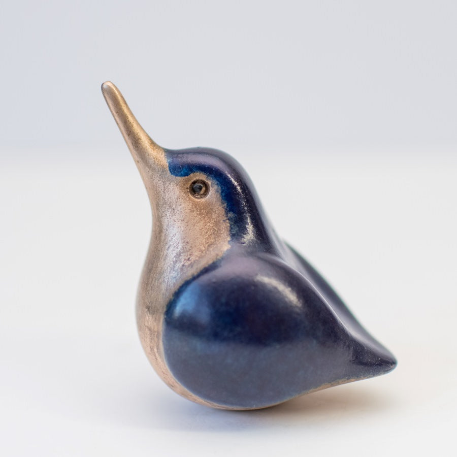 A small, foundry cast bronze kingfisher sculpture