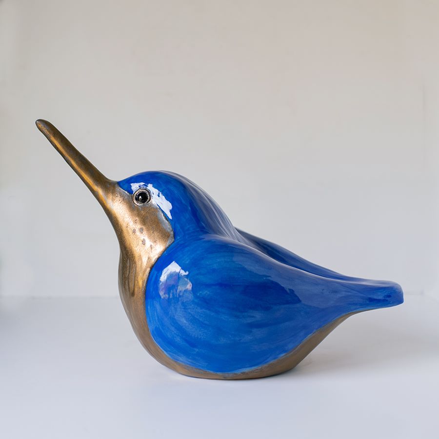 A bright blue and gold ceramic Kingfisher sculpture
