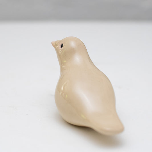 Small Ceramic Dove in a light beige color, viewed from the back and slightly to the side