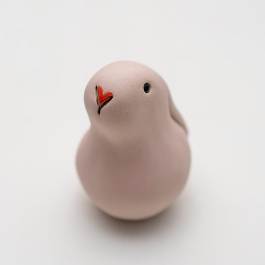 Small Pink Ceramic Bunny Sculpture with a red heart-shaped nose and black eyes