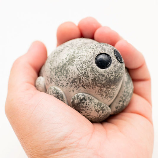 Grey Ceramic Spider Sculpture held in a person's palm