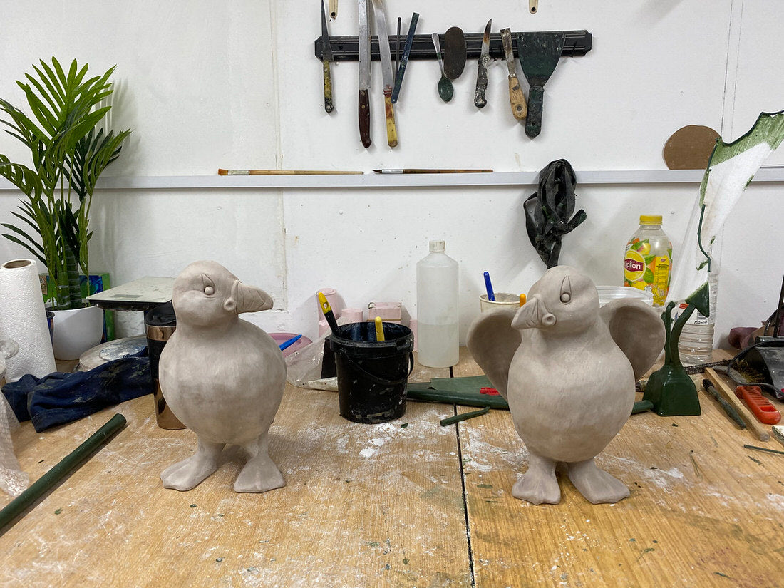Two clayPuffins on a workbench