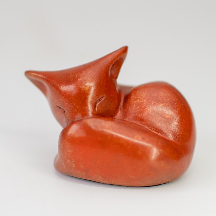 Small, collectable bronze fox sculpture in a bright orange patina