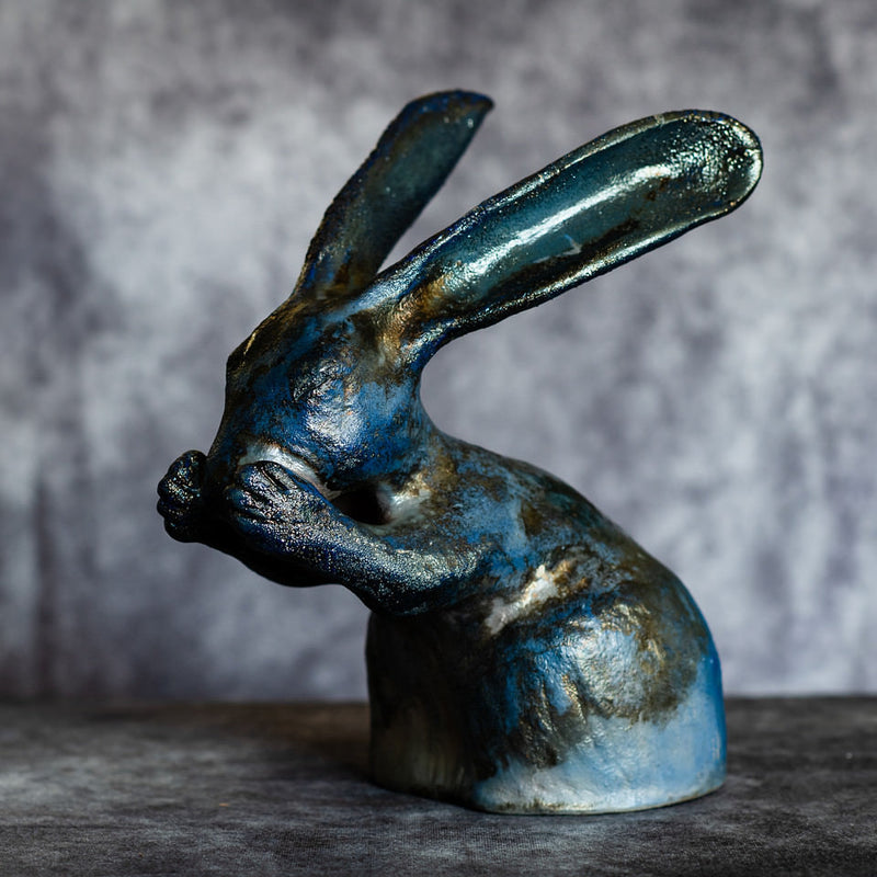 Vincent the ceramic hare sculpture - a blue raku fired hare washing his face