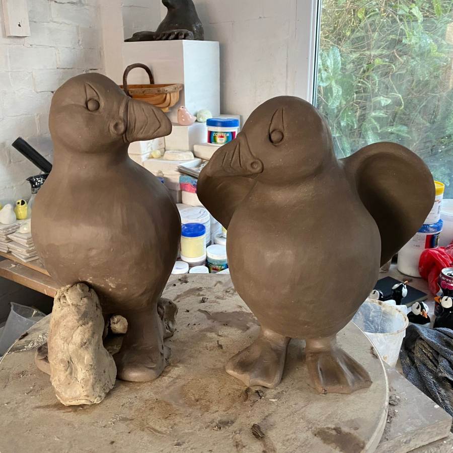 Two clay Puffin sculptures in progress