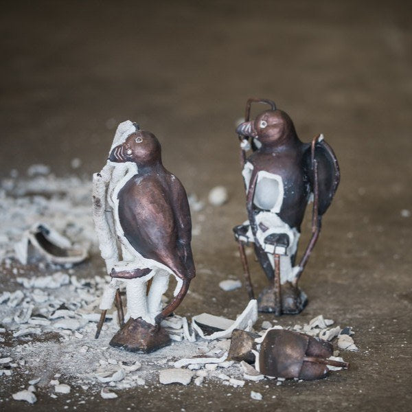 Two Puffin sculptures fresh from being cast in bronze with their ceramic shells removed