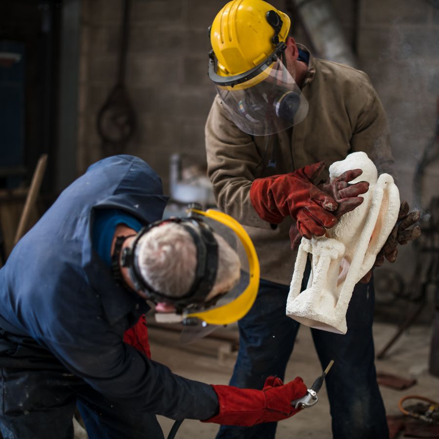 Arthur Flap's casting mould is held by Stephen as Andy blasts it with air to make sure it's clean for casting