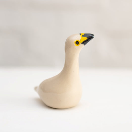 Small Ceramic Bewicks Swan Sculpture with a black and yellow beak and yellow eyes