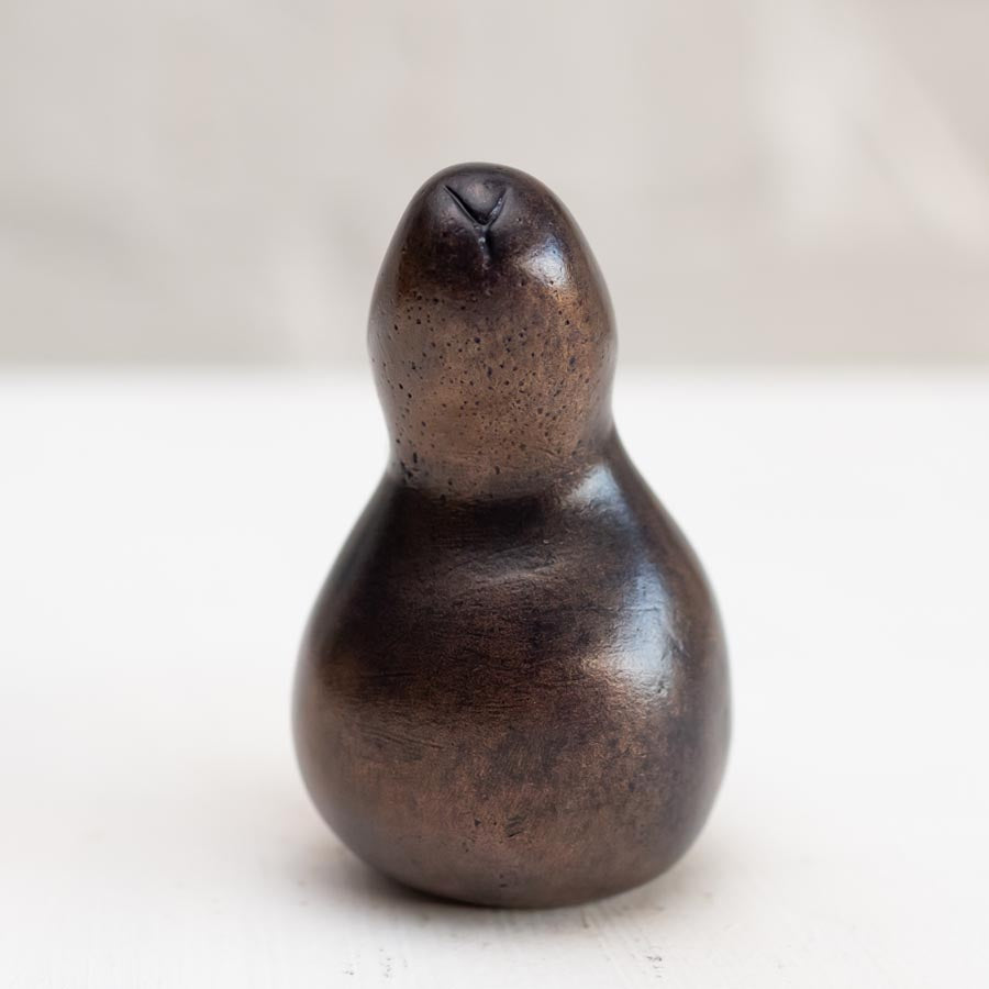 Brown bunny rabbit sculpture in bronze against a white background - front view