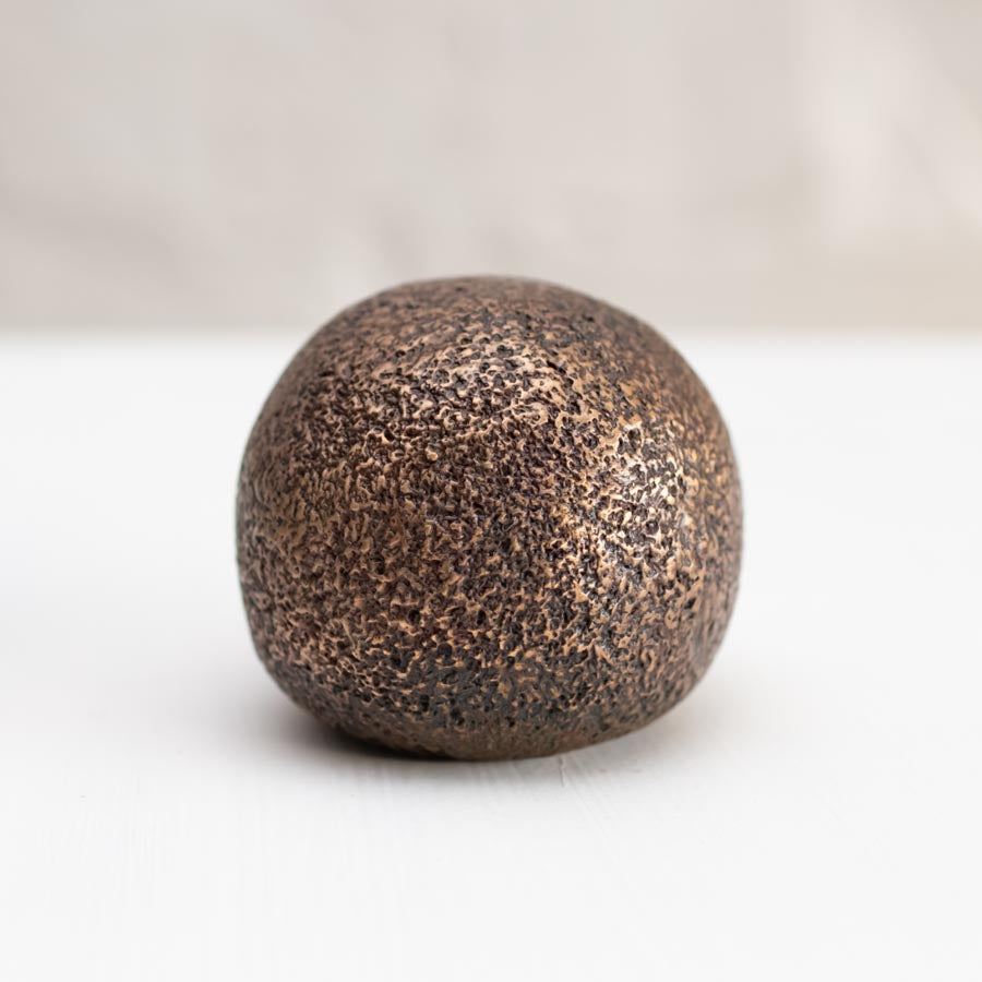 Small Bronze hedgehog sculpture back end view on white background