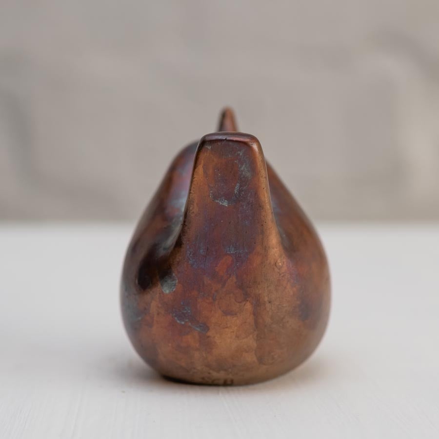 Small bronze wren sculpture against a white background - rear view
