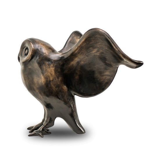A bronze owl with outspread wings