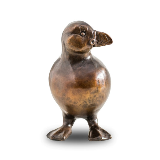 A bronze Puffin sculpture against a plain background