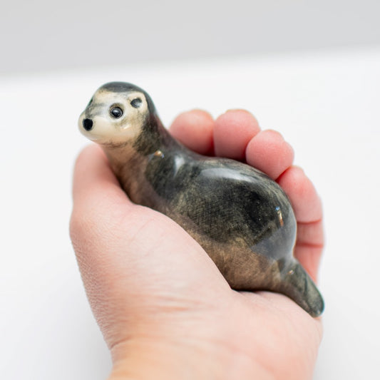 Small Ceramic Polecat Sculpture held in a hand