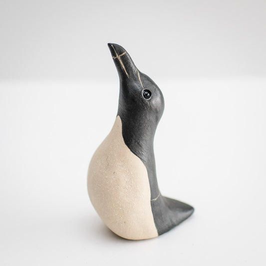 Ceramic Razorbill sculpture, black and beige, looking up