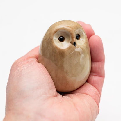 Ceramic Tawny Owl Sculpture held in a person's palm