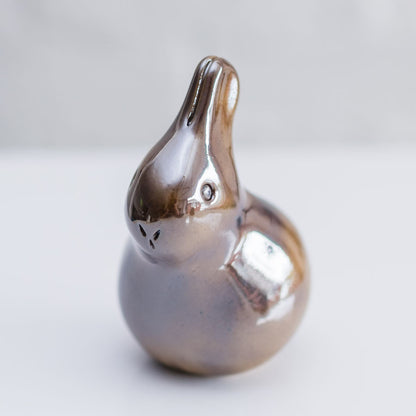 Small ceramic bunny sculpture in a brown metallic glaze