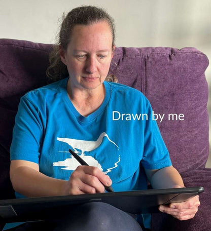 Sarah Brabbin sat on a purple sofa drawing on a tablet