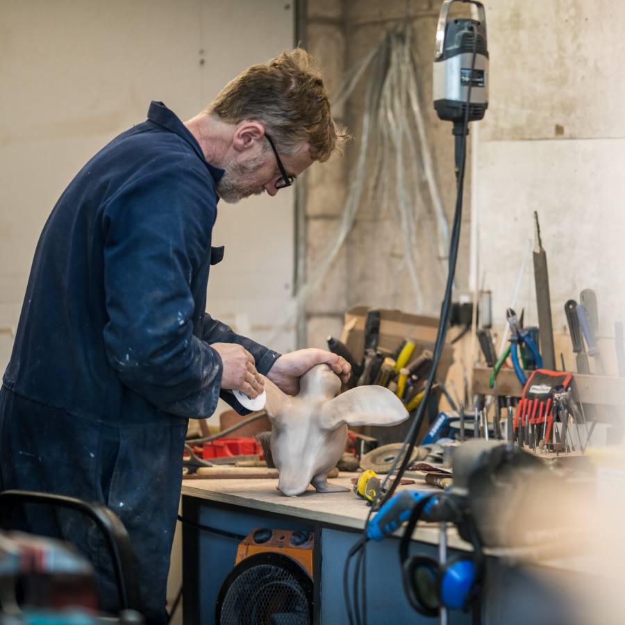 Foundry owner Stephen fettling Flippy Flappy on the workbench at the foundry