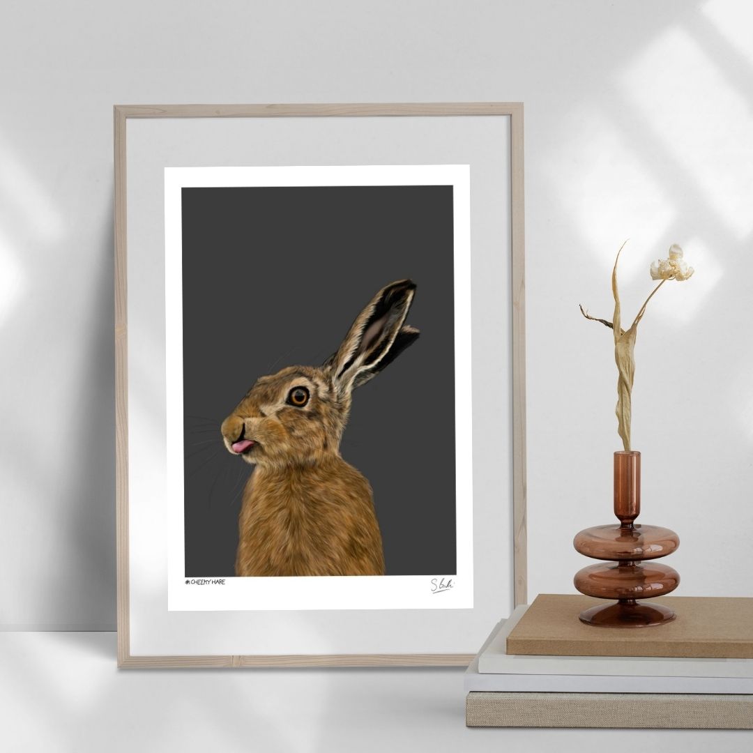 A detailed drawing of a hare in a frame against a white wall.