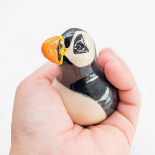 Joyful Pottery Puffin Sculpture held in a person's hand