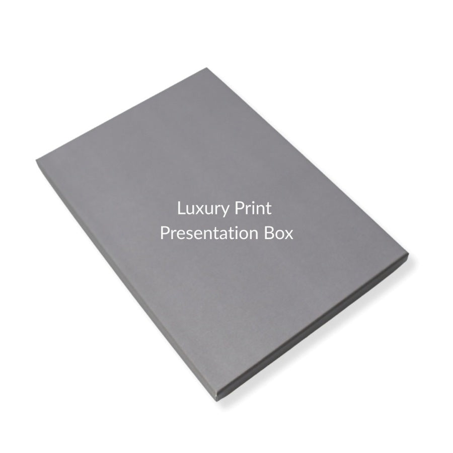 A grey rectangular presentation box shown at an angle on a white background, with the text 'Luxury Print Presentation Box' printed in white on the top surface.