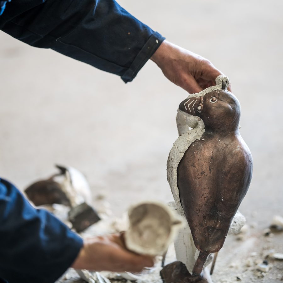 Bronze Puffin Billy being released from his ceramic casting shell