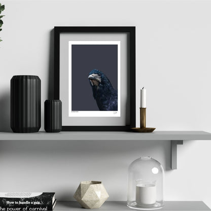 Rook artwork in a frame on a shelf with black vases and candles