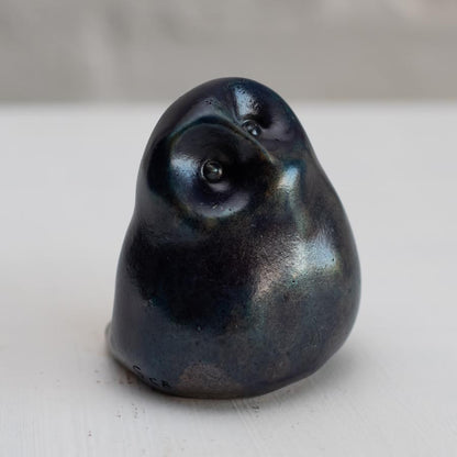 Deep blue small bronze owl sculpture on a white background