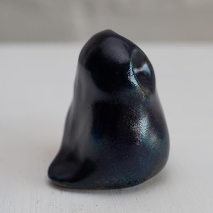 Deep blue small bronze owl sculpture on a white background - side view