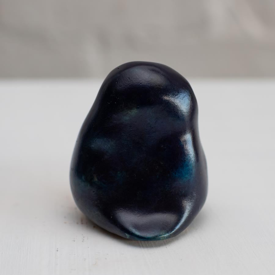 Deep blue small bronze owl sculpture on a white background - back view