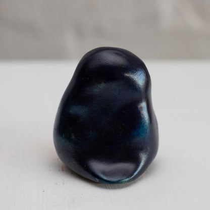 Deep blue small bronze owl sculpture on a white background - back view