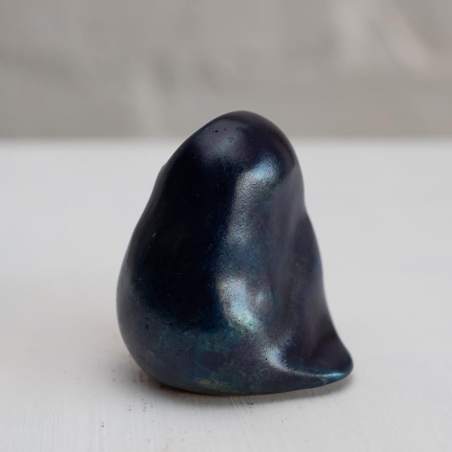 Deep blue small bronze owl sculpture on a white background - side view