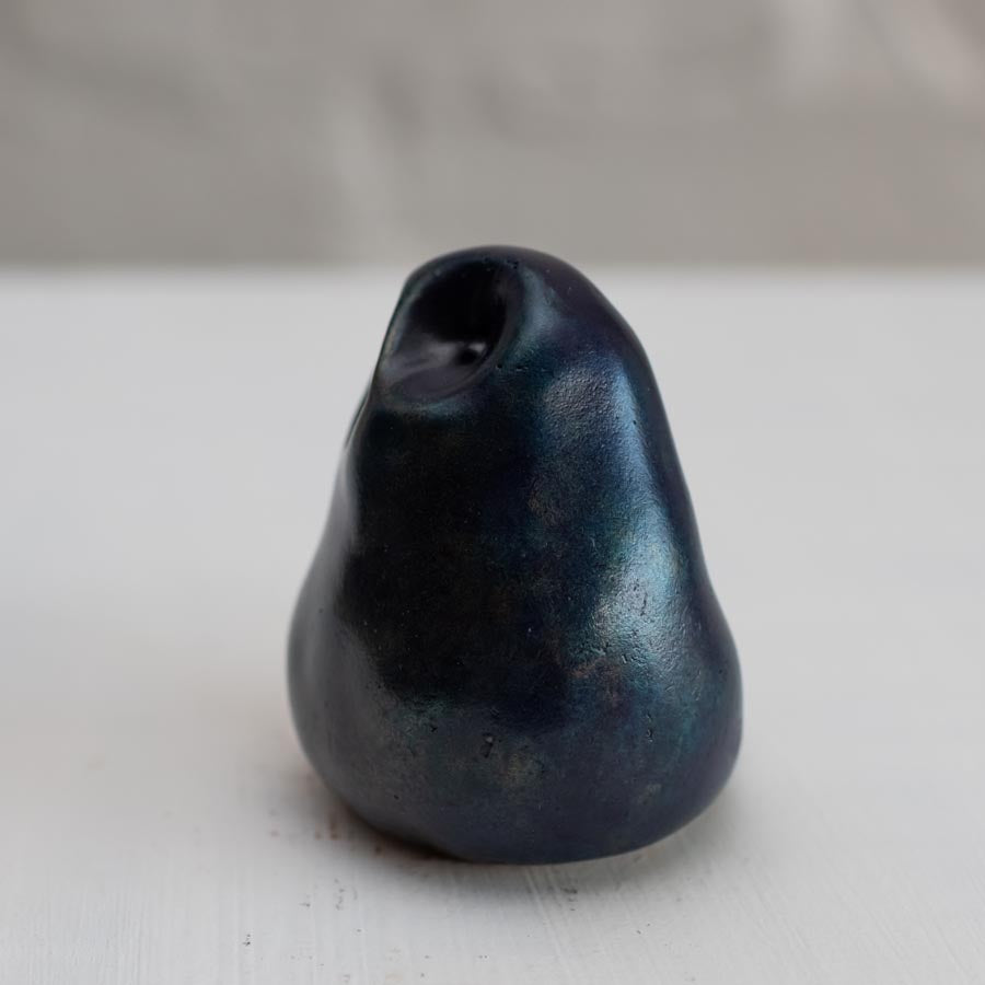 Deep blue small bronze owl sculpture on a white background - side view