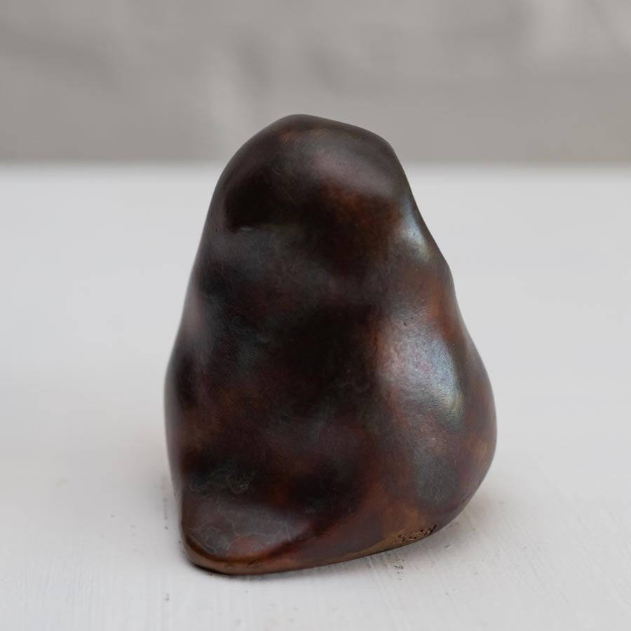 Brown coloured bronze owl sculpture against a white background side view]