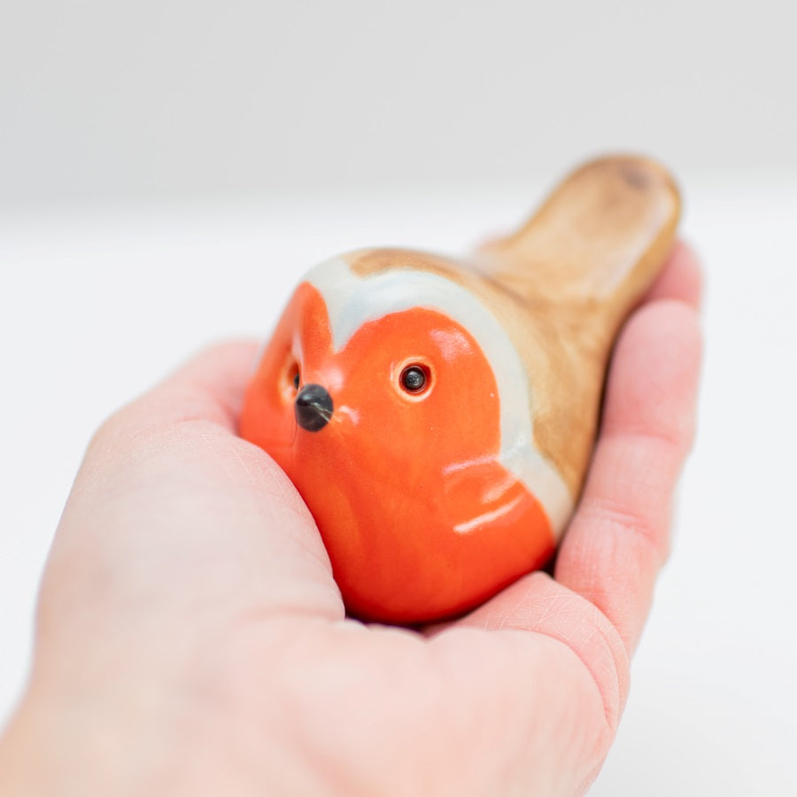 Ceramic robin held in a hand