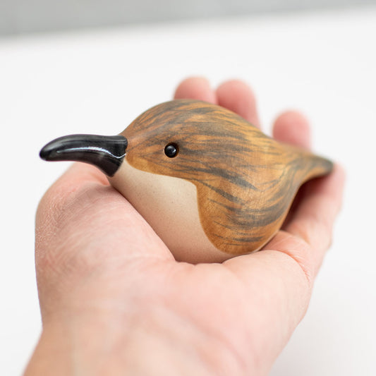 Small ceramic Treecreeper sculpture in a hand 