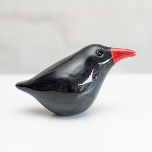 A small ceramic Chough sculpture against a plain background