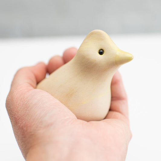 Small ceramic Skylark sculpture in a hand