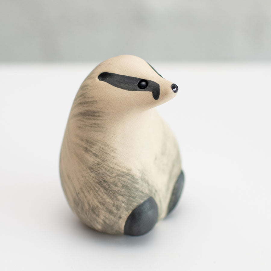 A small badger sculpture against a white background