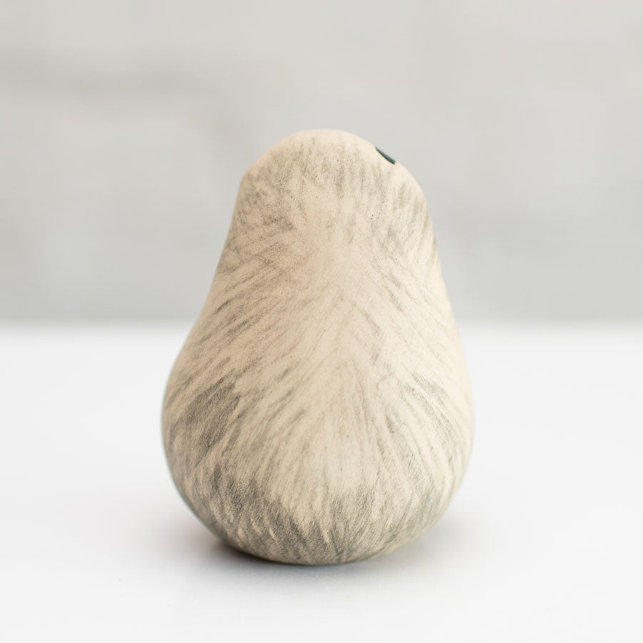 A small badger sculpture against a white background
