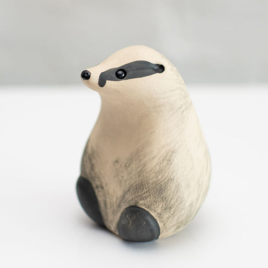 A small badger sculpture against a white background