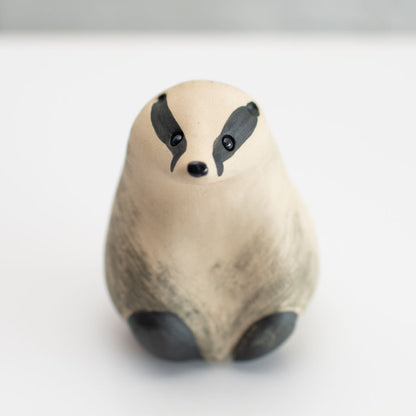 A small badger sculpture against a white background