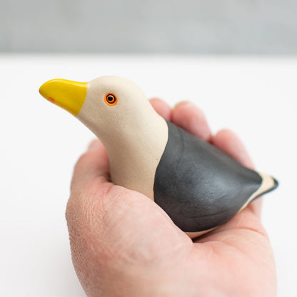 Small Ceramic Black Backed Gull sculpture in a hand