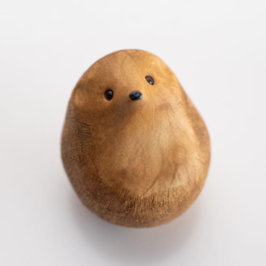 A small brown ceramic hedgehog sculpture