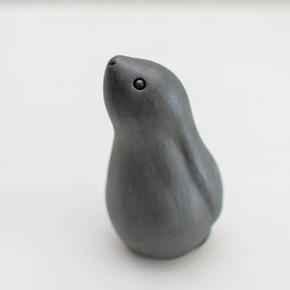 Black Moongazing Hare, a dark grey ceramic hare with small black eyes, looking upwards