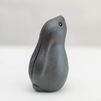 Black Moongazing Hare, a dark grey, smooth, abstract hare figurine with a small black eye